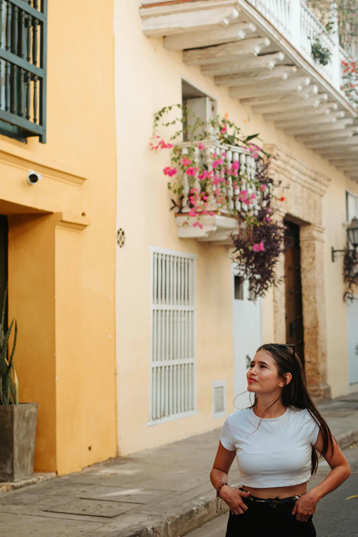 A young woman strolling through the vibrant streets of Cartagena de Indias, Colombia.
