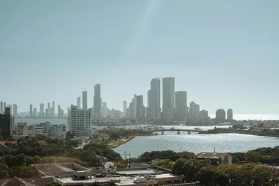 A stunning aerial view of Cartagena, showcasing modern skyscrapers and a serene waterway.