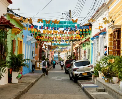 Colorful alley in Getsemani, Cartagena, Colombia, adorned with vibrant decorations and lively atmosphere.