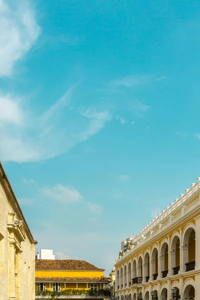 Explore the stunning colonial architecture against a blue sky in Cartagena, Colombia.