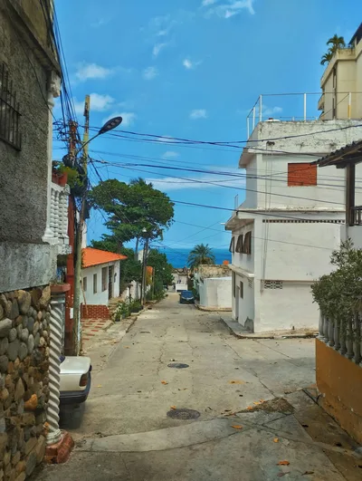 Picturesque street view towards the ocean on a bright day in a coastal town.