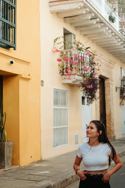 A young woman strolling through the vibrant streets of Cartagena de Indias, Colombia.